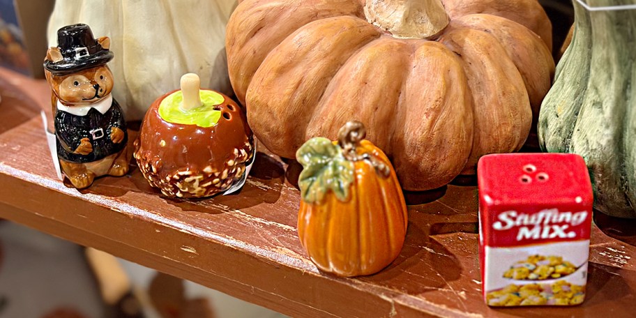 pilgrim, apple, pumpkin, and stuffing box salt and pepper shakers on table