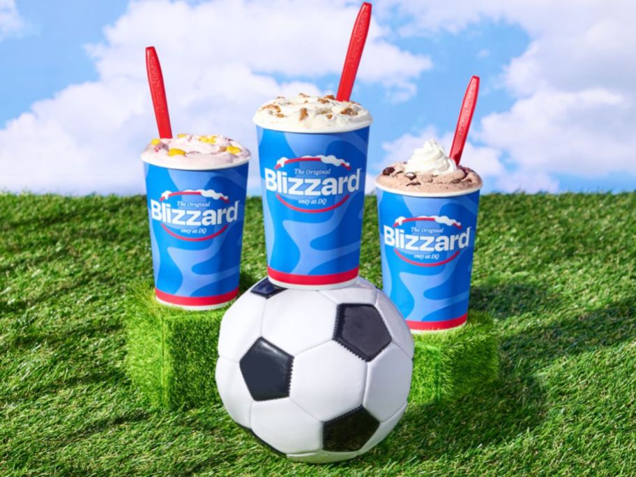 dairy queen blizzard cup lineup with soccer ball on turf