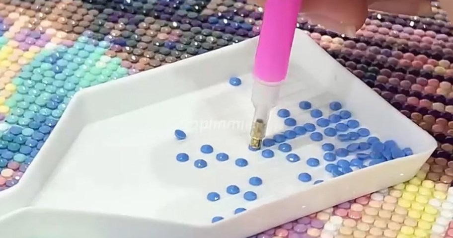 person using a diamond art kit