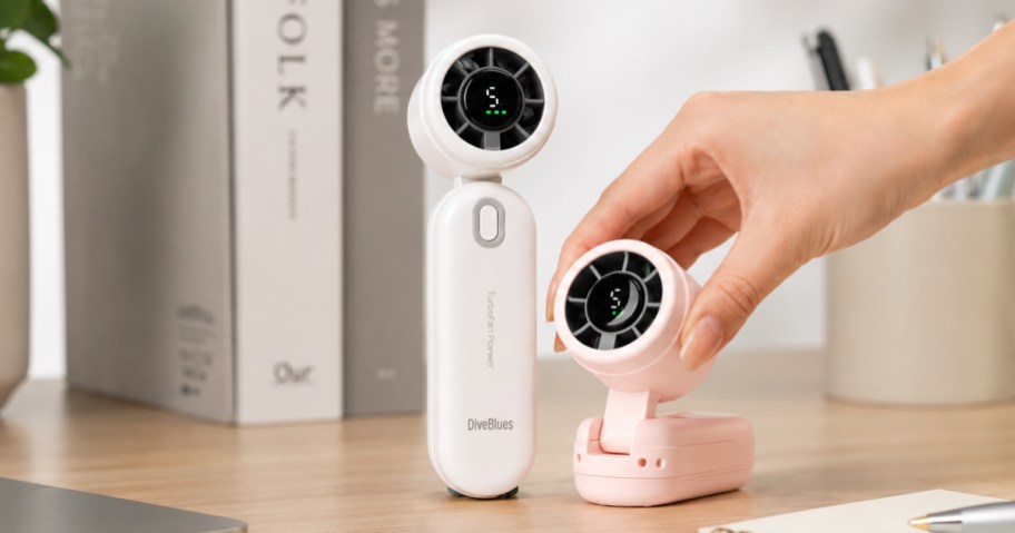 two personal fans on a desk
