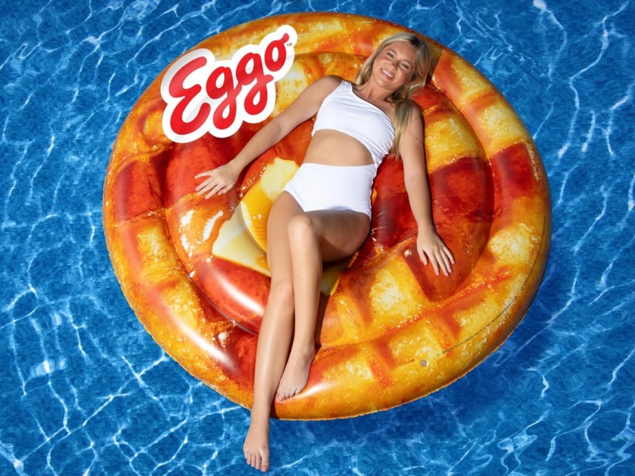 woman laying on a large Eggo Waffle float