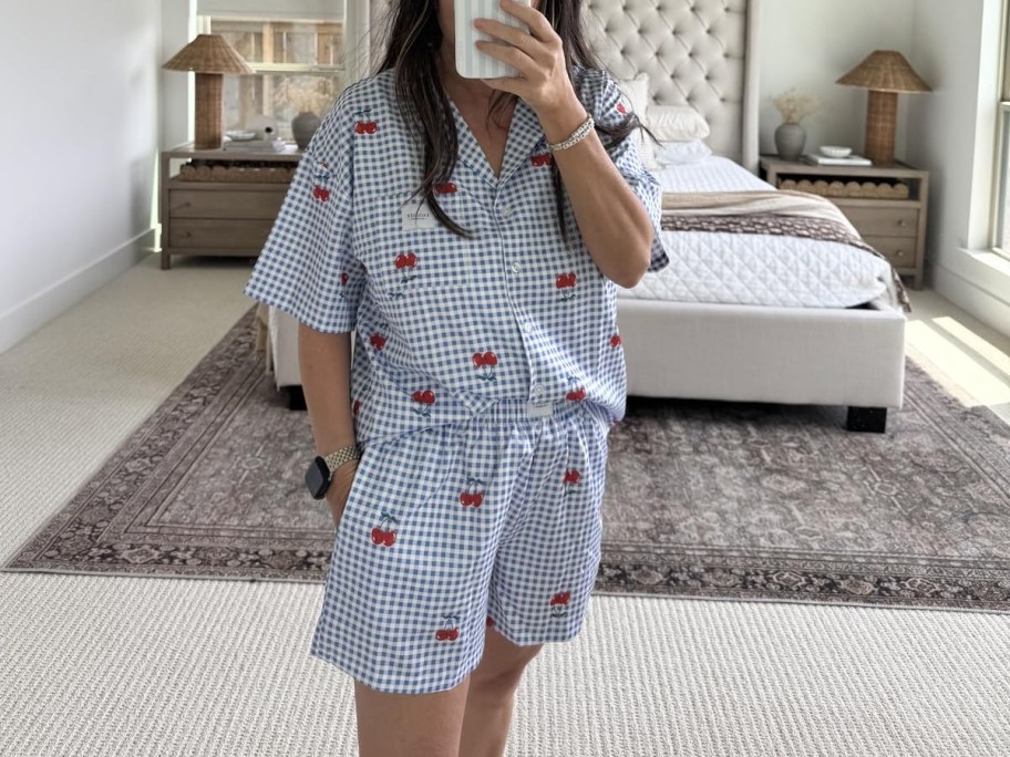 woman in pajamas taking mirror selfie
