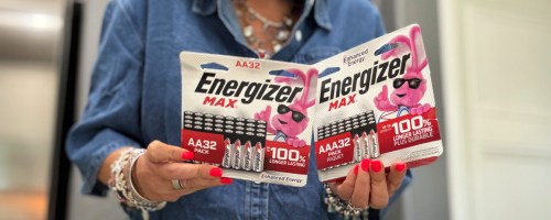 woman holding packages of energizer batteries