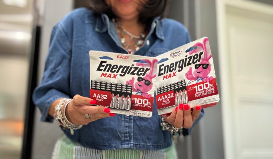woman holding packages of energizer batteries