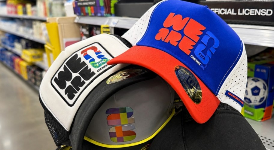 a hand holding 3 fifa caps