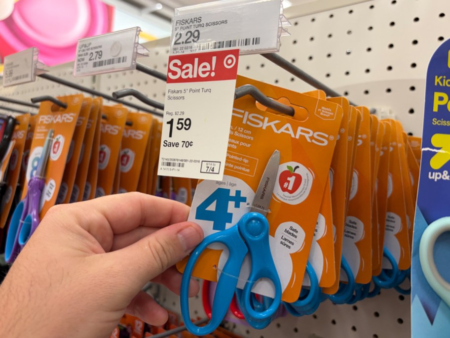 hand picking up fiscard scissors
