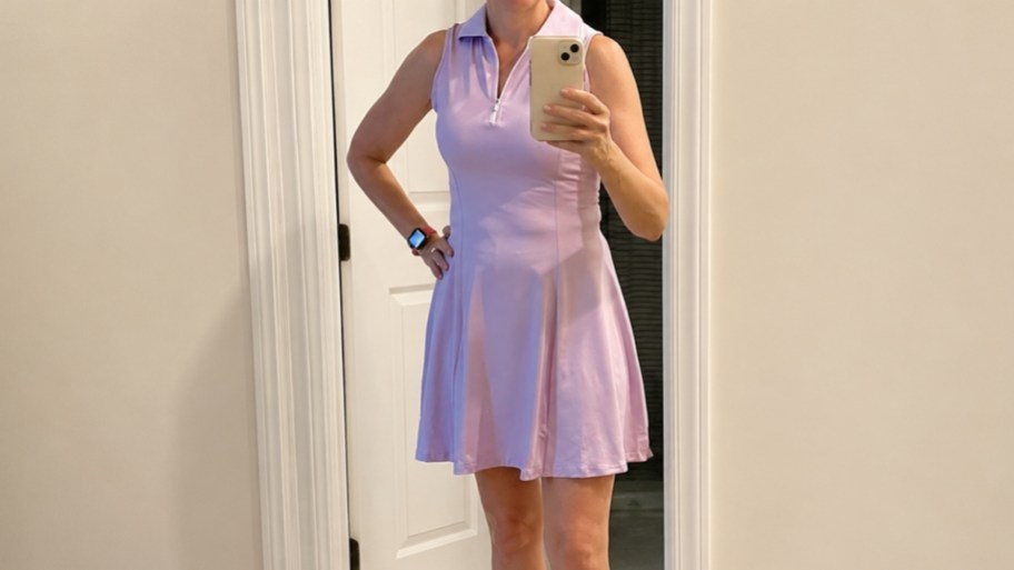 a woman in a lilac athletic dress taking a selfie