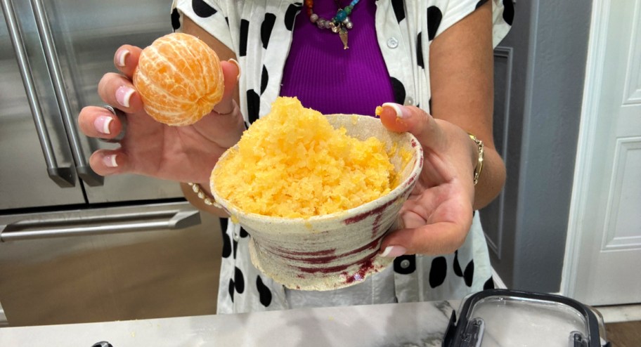 holding a frozen orange and shaved oranges