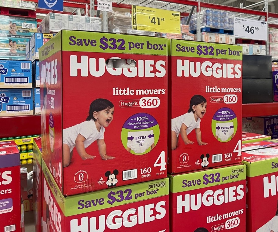 boxes of baby diapers stacked on display in a store