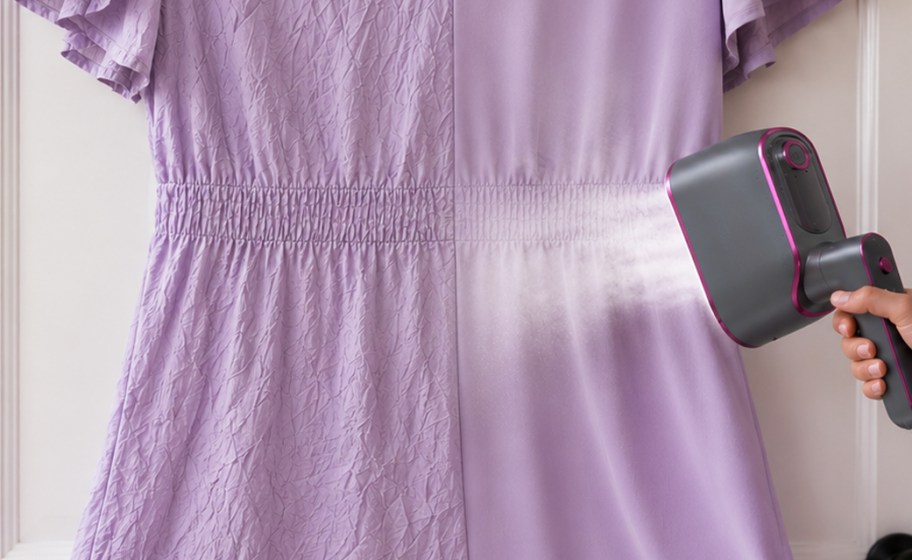 person steaming a dress