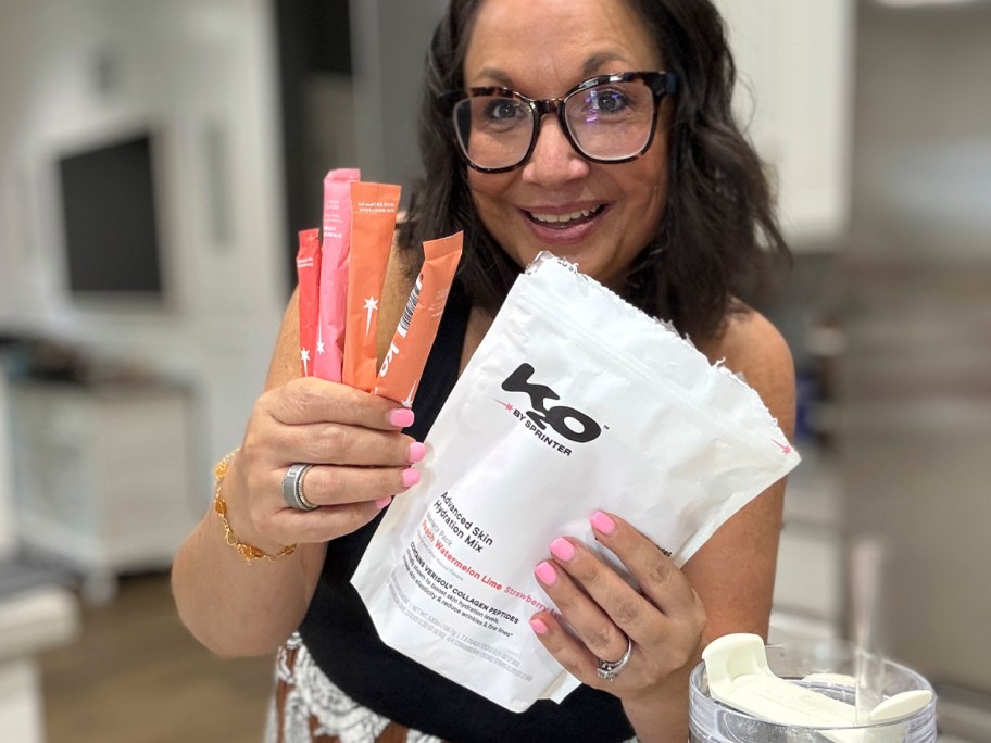 woman holding bag and packs of k20 hydration packs
