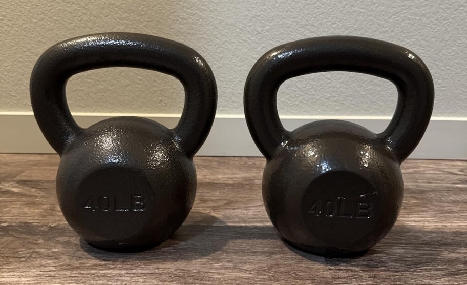 black kettlebells on wood floor
