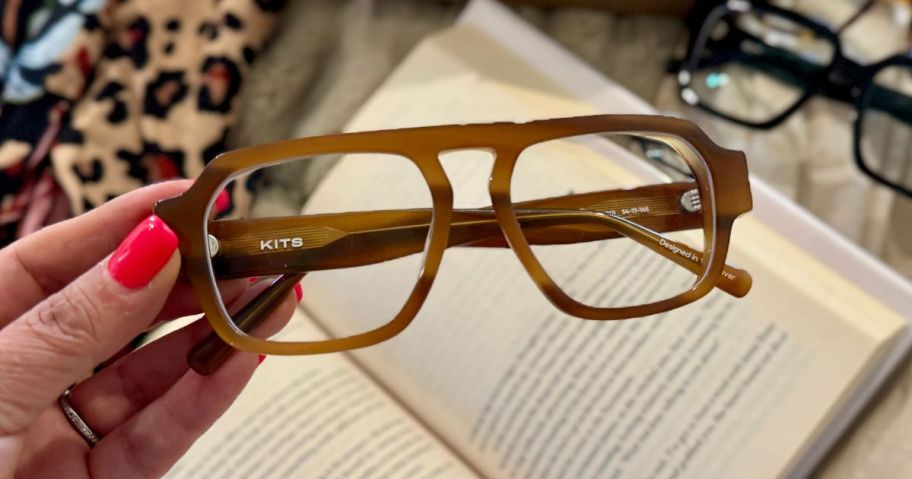 hand holding kits glasses