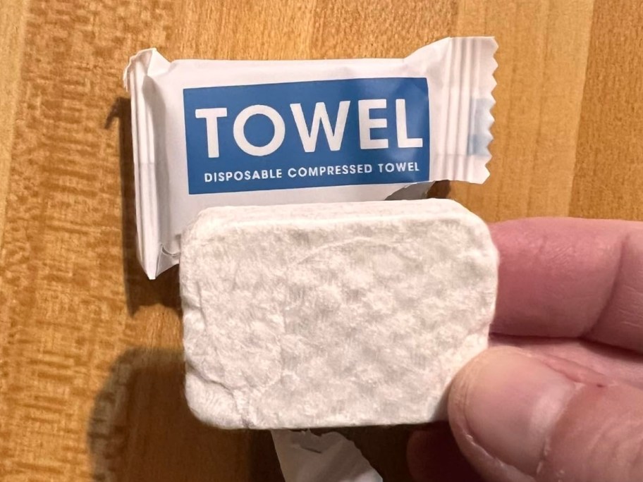 holding a compressed towel
