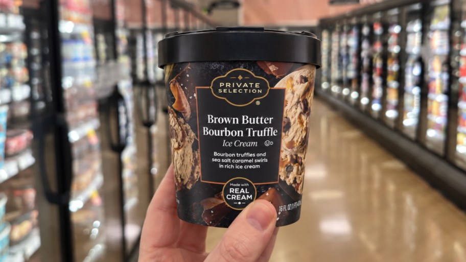 a hand holding a pint of ice cream