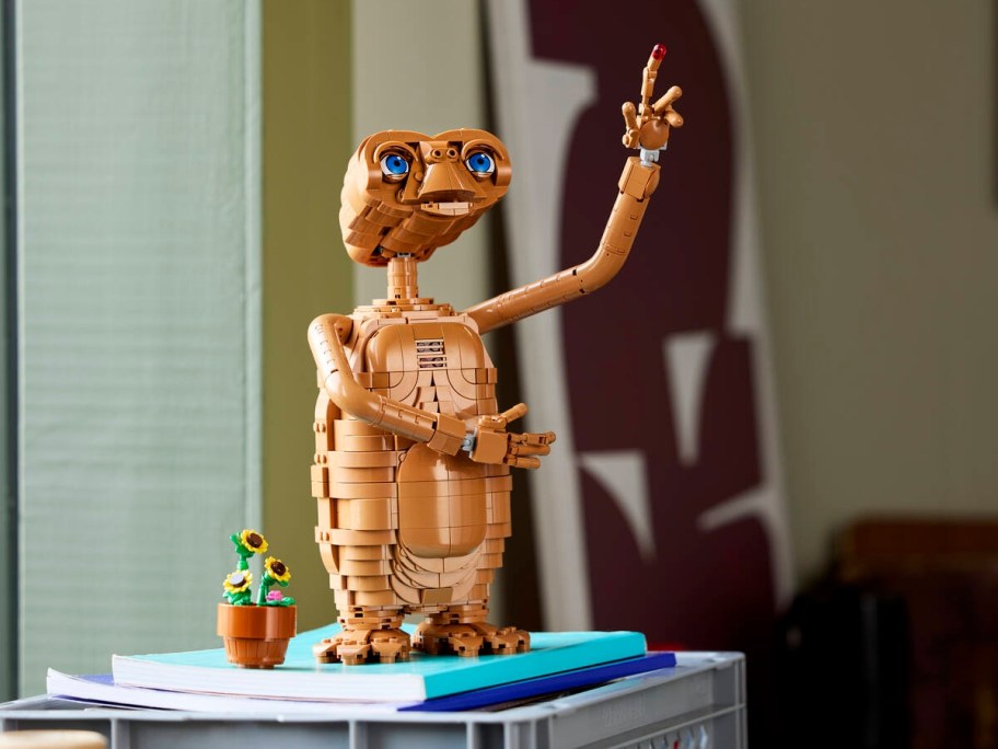LEGO ET character posed with one arm reaching upwards