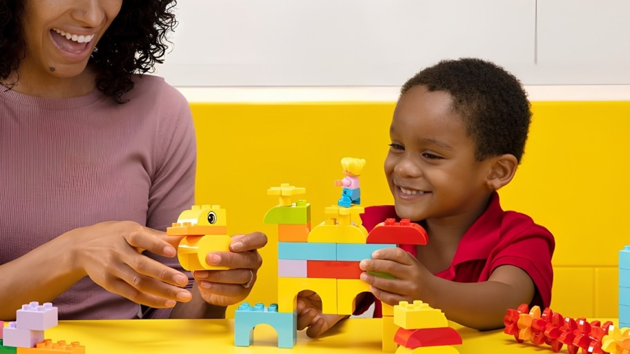 mom and little boy building a lego set