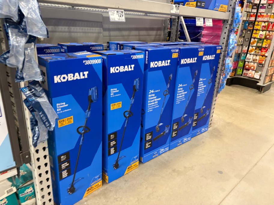 Kobalt products displayed on a shelf in a store, featuring multiple boxes of a trimmer.