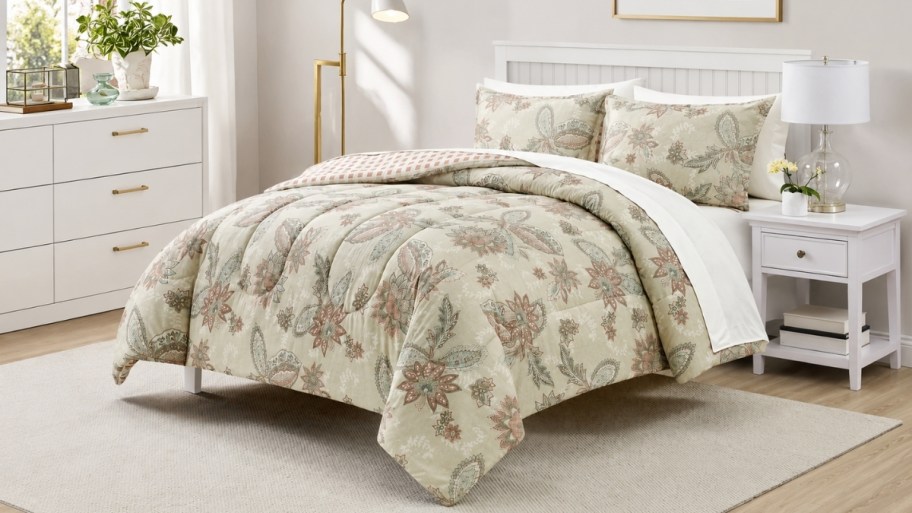 a floral print 3 piece comforter set on a bed.