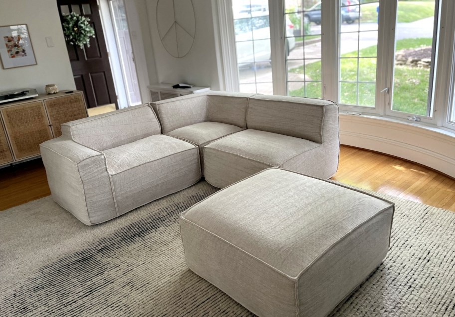 a beige modular sofa in four pieces