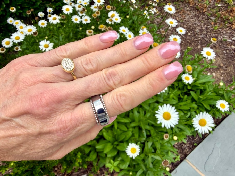 hand with silver rings on it 