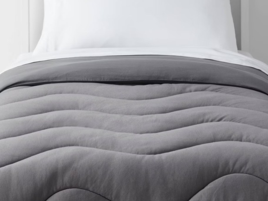 gray comforter on bed