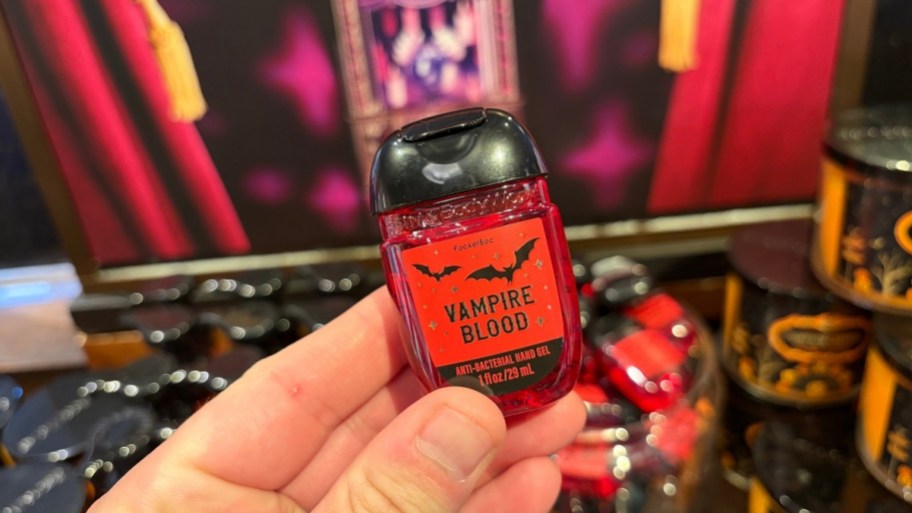 mnas hand holding a pocketbac hand sanitizer