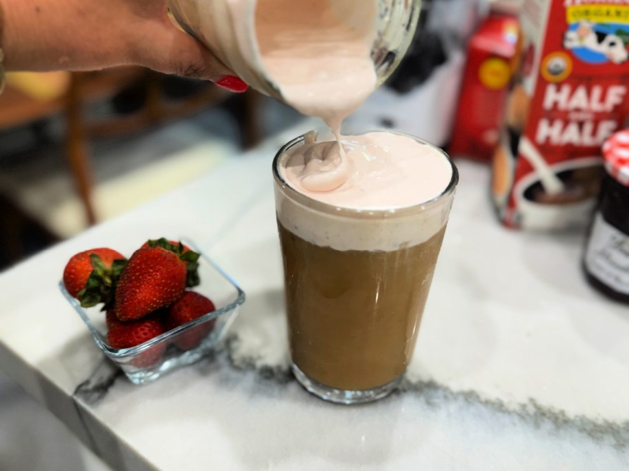pouring cold foam on a drink