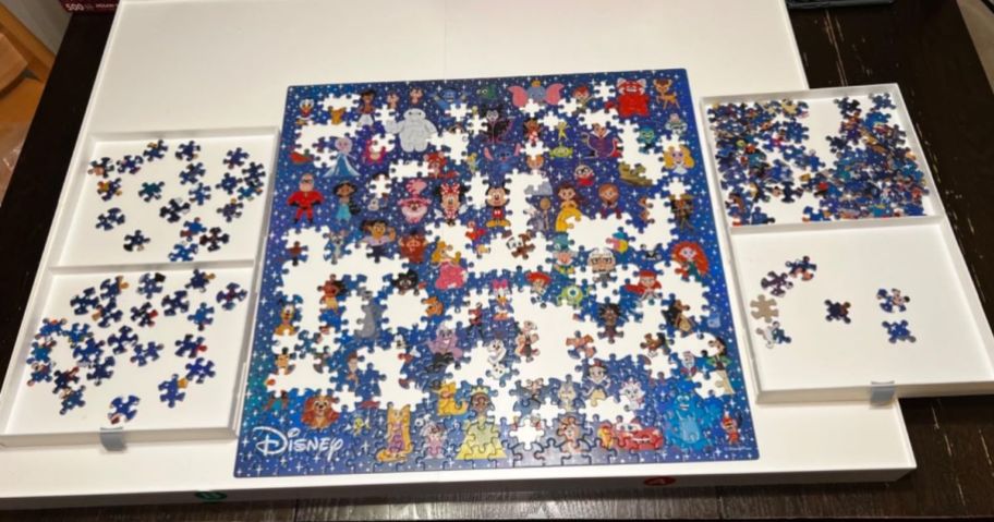 white puzzle table with a disney puzzle on top