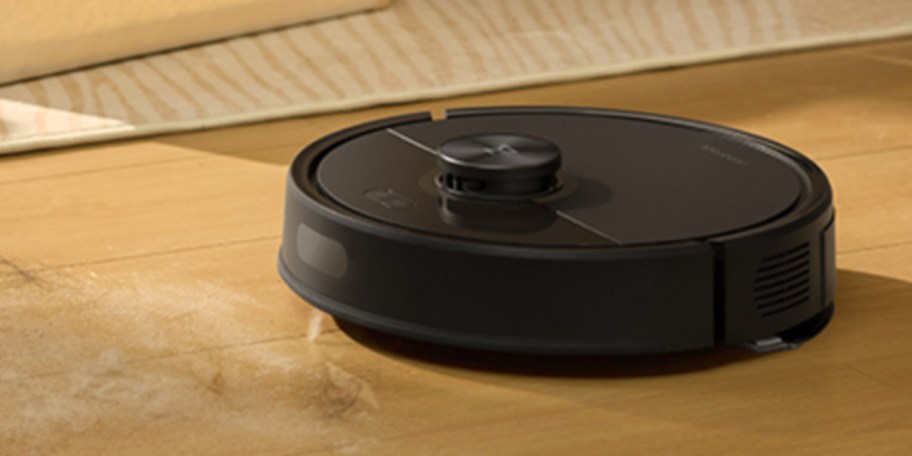 black robot vacuum mop cleaning floor