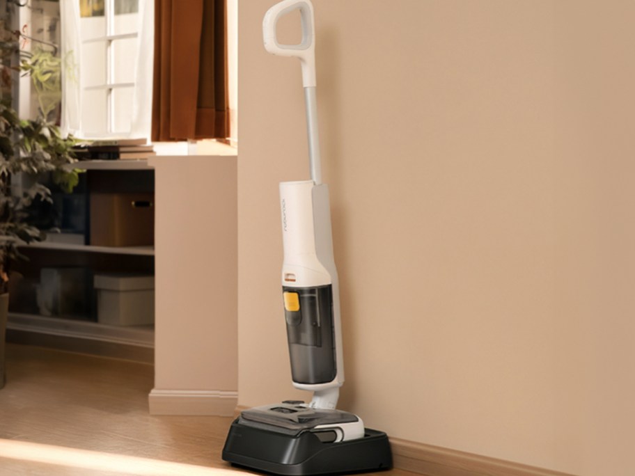 white vacuum mop on stand next to wall