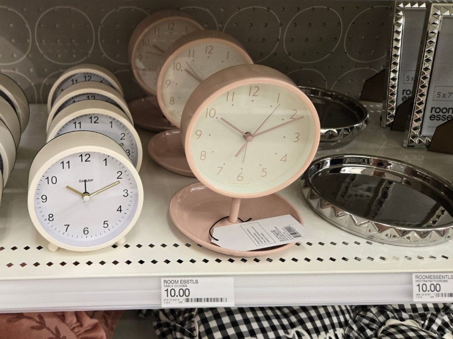 a pink trinket tray clock and small silver trinket tray on a store shelf