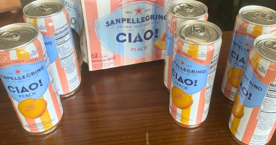 a box and cans of Sanpellegrino Ciao Peach flavor sparkling water