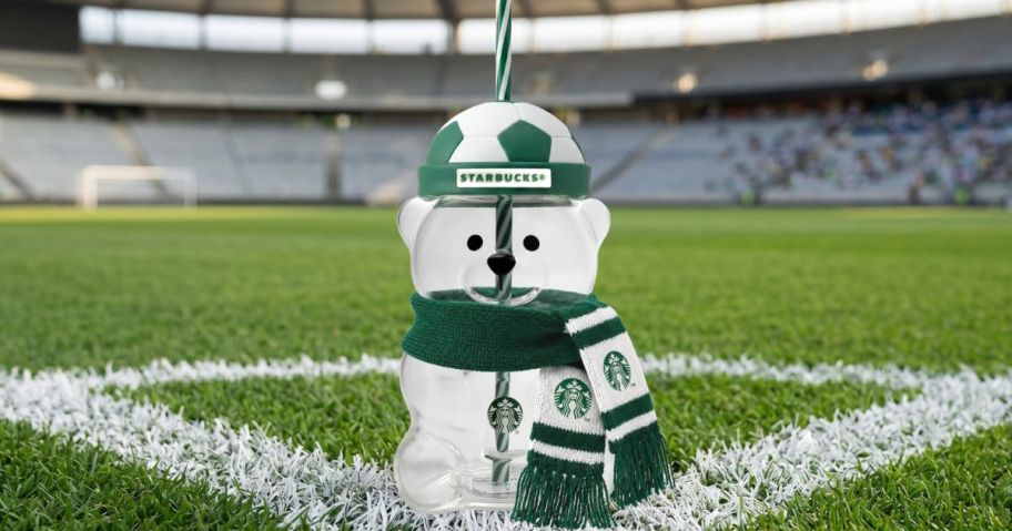 Bearista Cup featuring a soccer-themed hat on soccer field