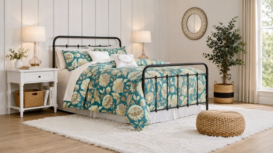 a black metal bed with headboard and footboard in a bedroom
