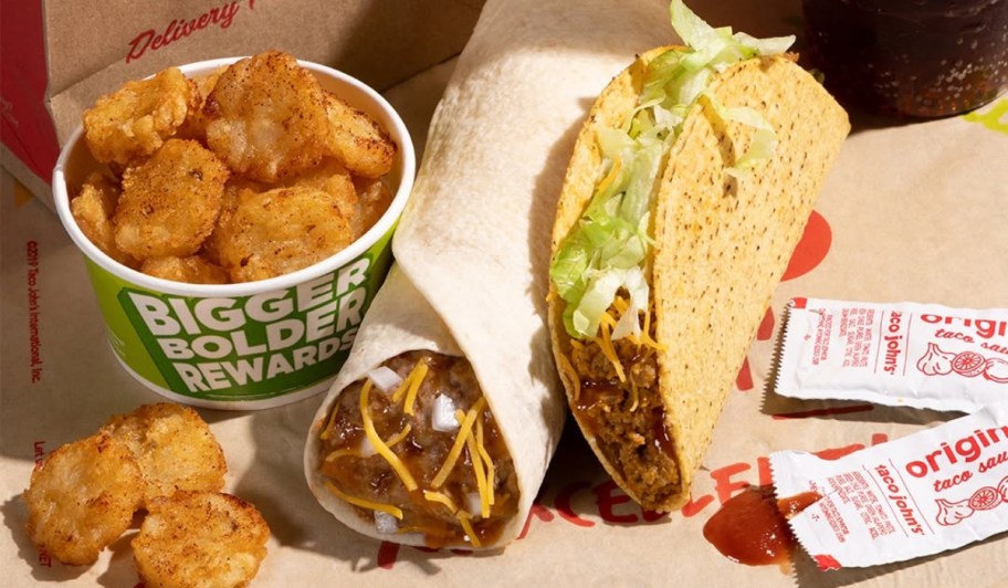 potato bites, burrito, and taco next to paper bag
