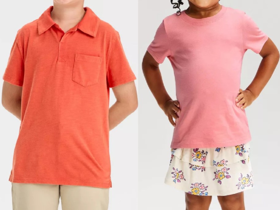 Two styles of children's Cat & Jack clothing displayed side by side, featuring an orange short-sleeve polo shirt with a chest pocket and khaki pants on the left, and a pink t-shirt paired with a white floral ruffled skirt on the right.