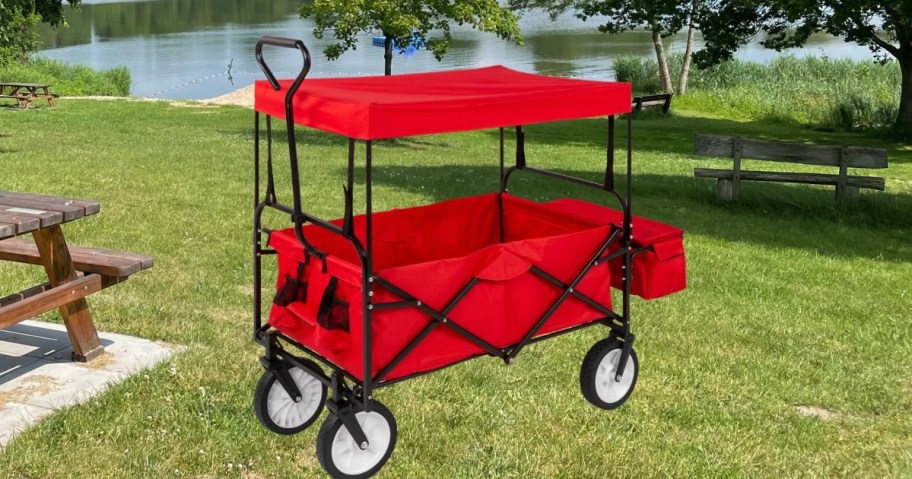 red foldable wagon in grass at park