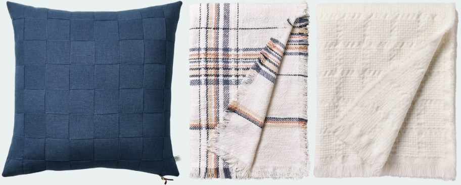 a blue throw pillow and two throws