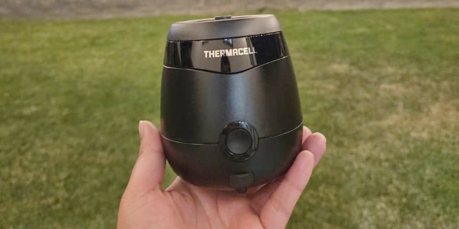 hand holding black thermacell repeller 