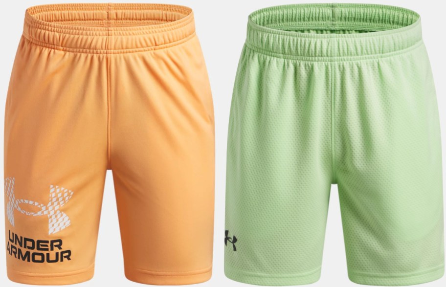 A pair of orange Under Armour shorts with a white patterned logo and a pair of light green mesh athletic shorts.