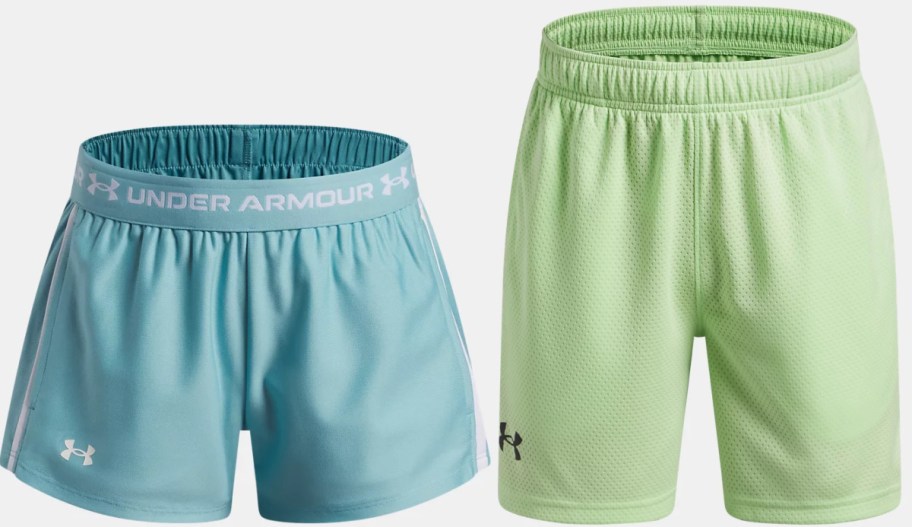 Two pairs of Under Armour athletic shorts side-by-side against a light background: a light blue pair with a branded waistband on the left, and a longer light green mesh pair on the right.