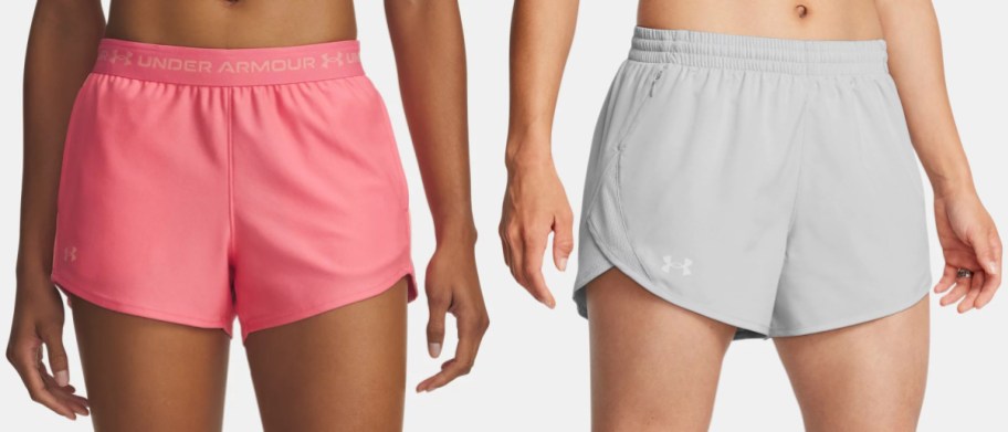 A pair of pink Under Armour athletic shorts with a branded waistband and a pair of light gray running shorts with side mesh panels.