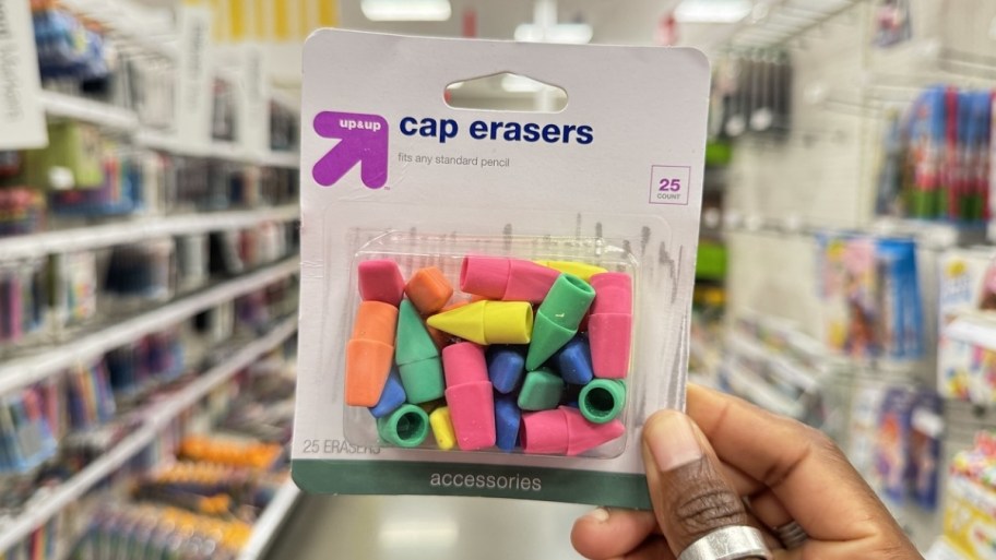 womans hand holding a pack of caperaser