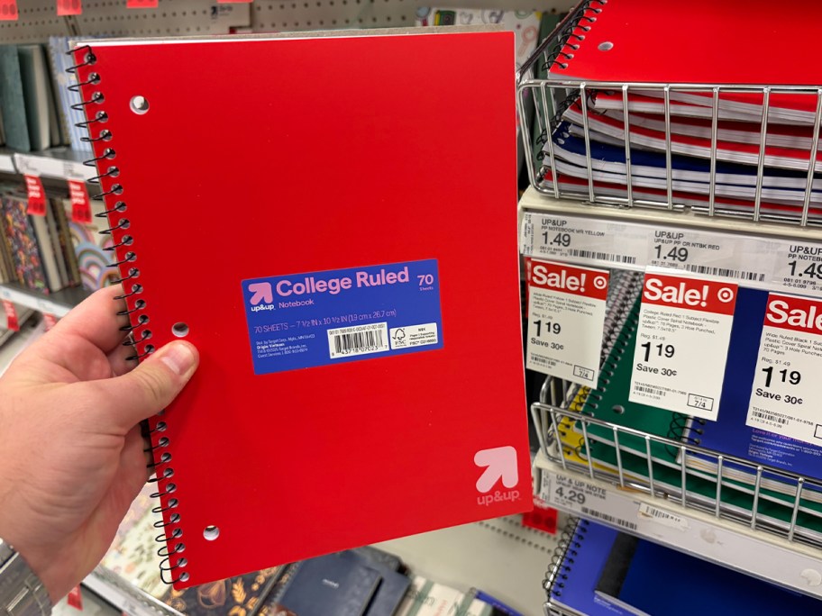 hand holding red laptop