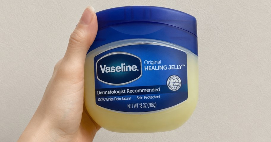 hand holding a jar of Vaseline