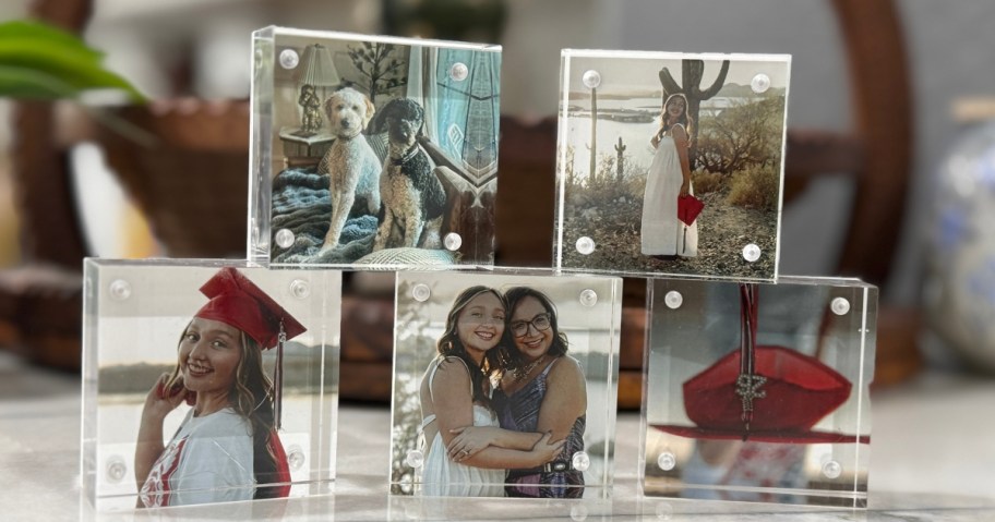 five acrylic photo blocks stacked on a counter
