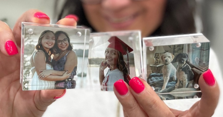woman holding 3 acrylic photo blocks