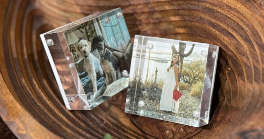 two acrylic photo blocks in a wood bowl