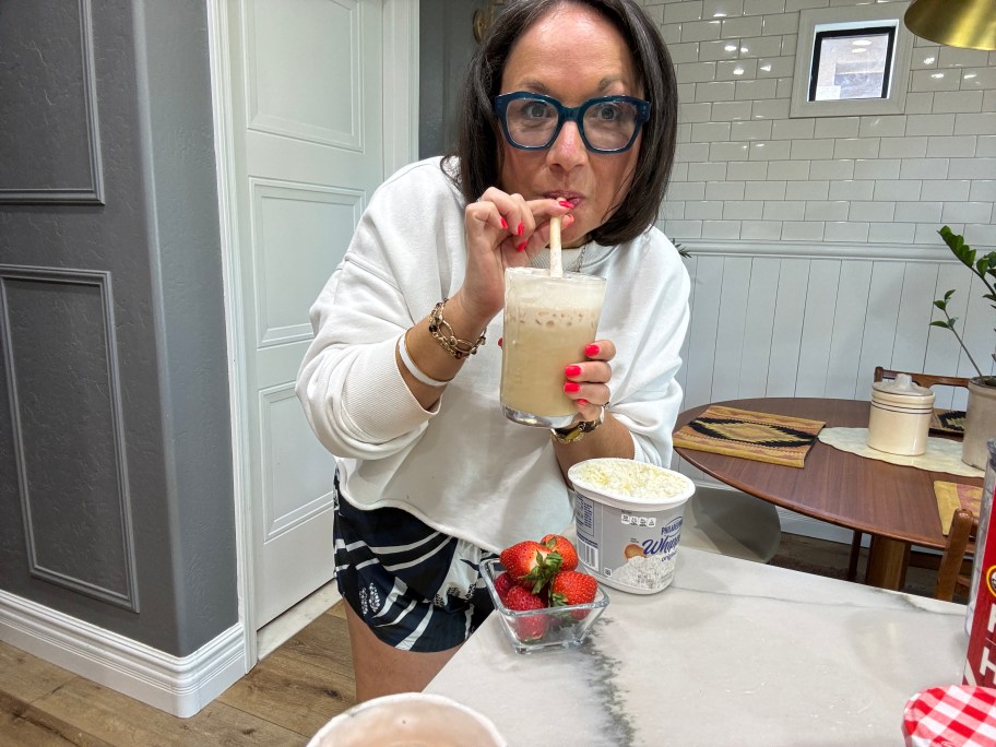 woman drinking a strawberry cold foam coffee